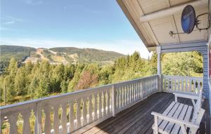 a porch with a white bench and a view of the mountains at Cozy Apartment In Sysslebck With Sauna in Sysslebäck