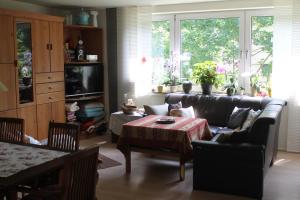 a living room with a couch and a table at Bed & Breakfast Bonn in Bonn