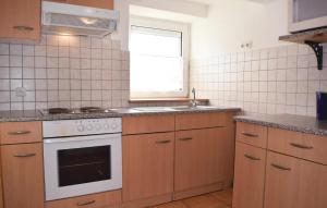 a kitchen with a stove and a sink and a window at Amazing Apartment In Trierweiler With 3 Bedrooms And Wifi in Trierweiler