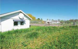 a white house with a satellite dish on the side of a field at 2 Bedroom Stunning Home In Borgholm in Borgholm