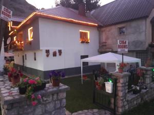a house with a tent and flowers in the yard at Vila MAGDA in Mavrovo +21 photos