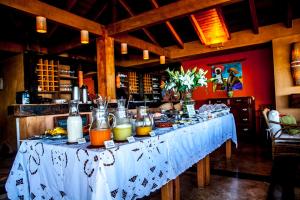 a table with a buffet of food on it at Solar Mirador Exclusive Resort e SPA in Praia do Rosa