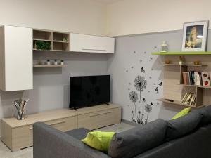 a living room with a couch and a flat screen tv at B&B La Corte in Santa Maria Capua Vetere