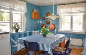 マリアネルンドにあるBeautiful Home In Mariannelund With 2 Bedroomsの青い壁のキッチン(テーブル付)