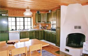 a kitchen with a table and a fireplace at Stunning Home In Trnaby With Kitchen in Tärnaby