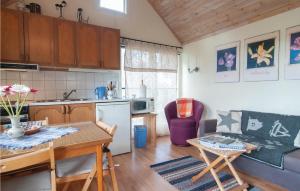 a kitchen and living room with a table and a dining room at Gorgeous Studio In Visby With Wifi in Fole