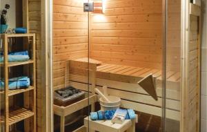 a sauna with a wooden wall and a glass door at Stunning Home In Boiensdorf With Sauna in Boiensdorf