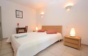 a bedroom with a bed and a table and a chair at Lovely Home In Montbrison Sur Lez in Peyrol