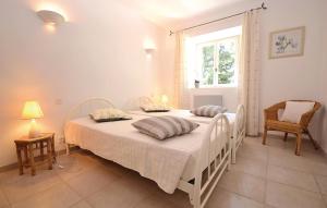 a white bedroom with a bed and a window at Lovely Home In Montbrison Sur Lez in Peyrol +25 photos