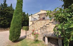 a house with a stone staircase and a tree at Lovely Home In Montbrison Sur Lez in Peyrol