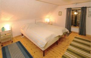 a small bedroom with a bed and a window at Two-Bedroom Holiday Home In Ystad in Ystad