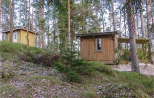a small wooden cabin in the woods with trees at One-Bedroom Holiday Home Vittsjö 0 07 in Visseltofta