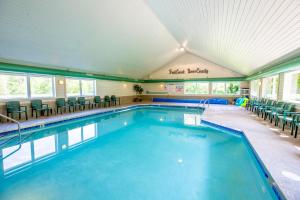 a large swimming pool with chairs in a building at Parkwood Lodge in Fish Creek