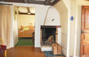 a living room with a fireplace and a bedroom at 2 Bedroom Beautiful Home In Linneryd in Linneryd
