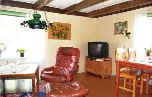 a living room with a leather chair and a television at 2 Bedroom Beautiful Home In Linneryd in Linneryd