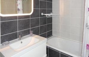 a bathroom with a sink and a bath tub at Nice Apartment In Gruissan With Kitchen in Gruissan