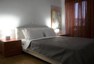 a bedroom with a large bed and two night stands at Modern & Classy Central Apartment in Athens