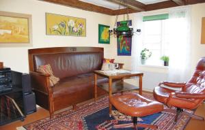 a living room with a leather couch and a table at 2 Bedroom Beautiful Home In Linneryd in Linneryd +10 photos