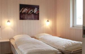 a bed in a room with two pillows on it at Friedrichskoog-Deichblick 3 in Friedrichskoog