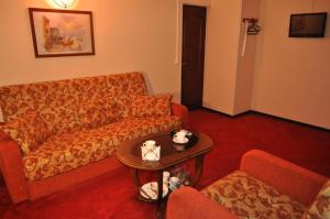 a living room with a couch and a table at Family hotel on the lake Lakada in Gribki