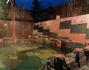 a room with a stone floor and a wall at Hotel Grand Toya in Lake Toya
