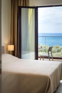 a bedroom with a bed and a view of the ocean at Adria lux apartmens 2 in Sveti Stefan