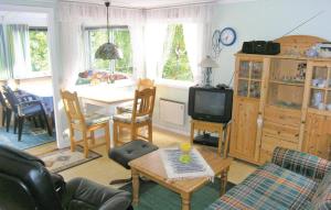 ein Wohnzimmer mit einem Sofa und einem Tisch mit einem TV in der Unterkunft Stunning Home In Sderkra With 1 Bedrooms in Söderåkra