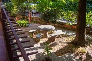 a bench and a table next to a tree at Casa dei Laghi in Viterbo