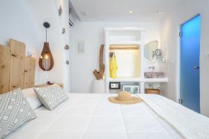 a bedroom with a bed with a hat on it at Naxos Island Escape Suites in Plaka