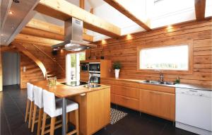 a kitchen with wooden walls and a wooden counter top at Beautiful Home In Aneby With Wifi in Aneby +5 photos
