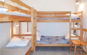 a bunk bed room with two bunk beds and a chair at Lovely Apartment In Ystad With Kitchen in Ystad