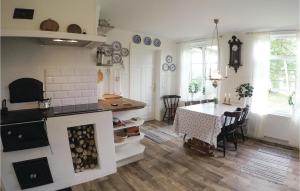 a kitchen and dining room with a table and a dining room at Beautiful Home In Högsby With Kitchen in Fågelfors +11 photos