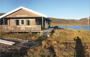a house on the side of a body of water at Tjeldøya in Dragland