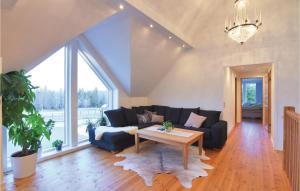 a living room with a couch and a table at Beautiful Home In Aneby With Wifi in Aneby