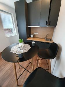 a small kitchen with a table and two chairs at Oak house apartments in Kaunas