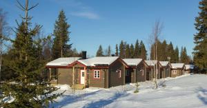 Vålkojan Naturby - Timber cottages under vintern