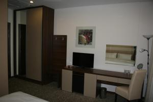 a hotel room with a desk and a television at Hotel Franca in Bijelo Polje
