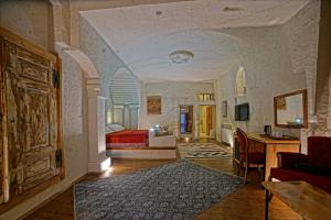 a living room with a bed and a couch at Taru Cave Suites in Urgup