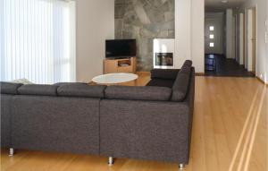 a living room with a couch and a table at Nice Home In Farsund With 4 Bedrooms in Farsund