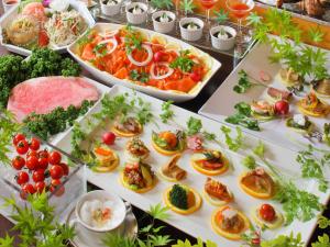 a buffet filled with different types of food on plates at Asaya in Nikko