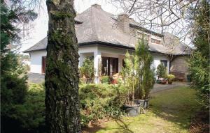 a house with a tree in front of it at 1 Bedroom Cozy Apartment In Schönecken in Schönecken