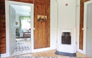 a living room with a fire place in a room at Holiday Home Hagen Barnebo Blomstermåla in Barnebo