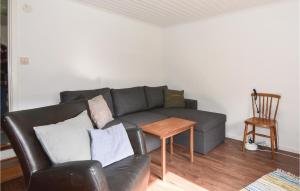 a living room with a couch and a table at 2 Bedroom Stunning Home In Strömstad in Lommeland