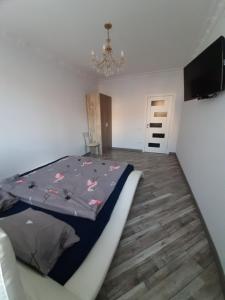 a bedroom with a bed with pink butterflies on it at Apartment in Serbska Lviv in Lviv