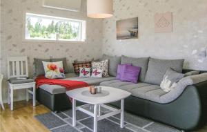 a living room with a couch and a table at Lovely Home In Bolmsö With Kitchen in Bolmsö +9 photos