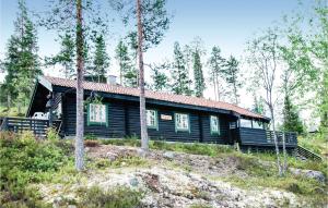 a log cabin in the woods with trees at 4 Bedroom Stunning Home In Rendalen in Rendalen