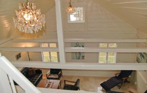 a staircase in a house with a chandelier at Lovely Home In Mellerud With Kitchen in Mellerud +9 photos