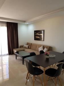 - un salon avec un canapé et une table dans l'établissement Saramica Seaside apartment, à Fnideq