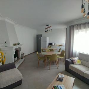 a living room with a table and a couch at Baixinho Guest House in Vila Praia de Âncora