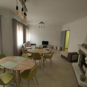 a living room with tables and chairs and a couch at Baixinho Guest House in Vila Praia de Âncora